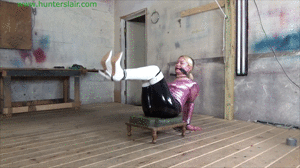 jimhunterslair.com - Cruelly hogtied with thin leather cords in her shiny white boots thumbnail